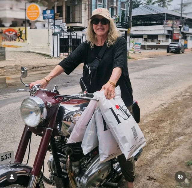 Maureen on a motorcycle in Sri Lanka with shopping bags